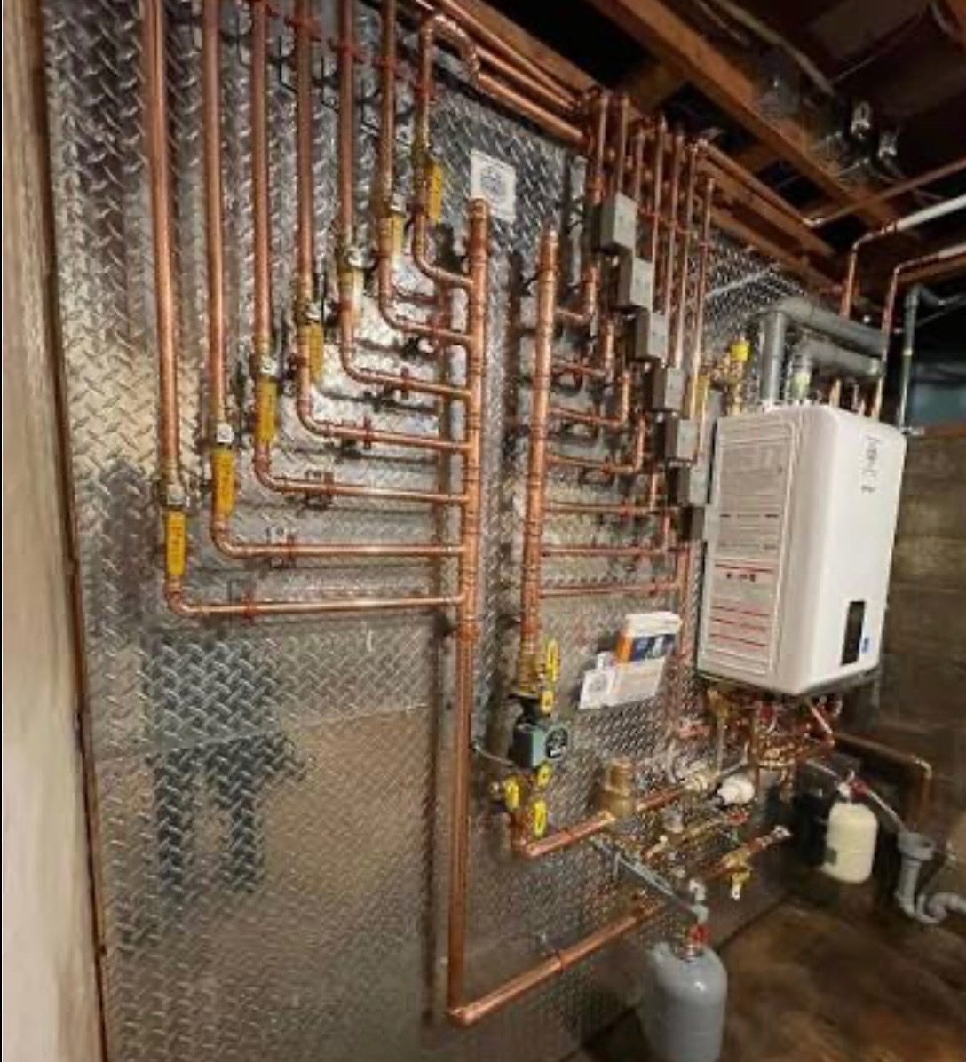 Copper piping and tankless water heater installed by Sphinx Mechanical