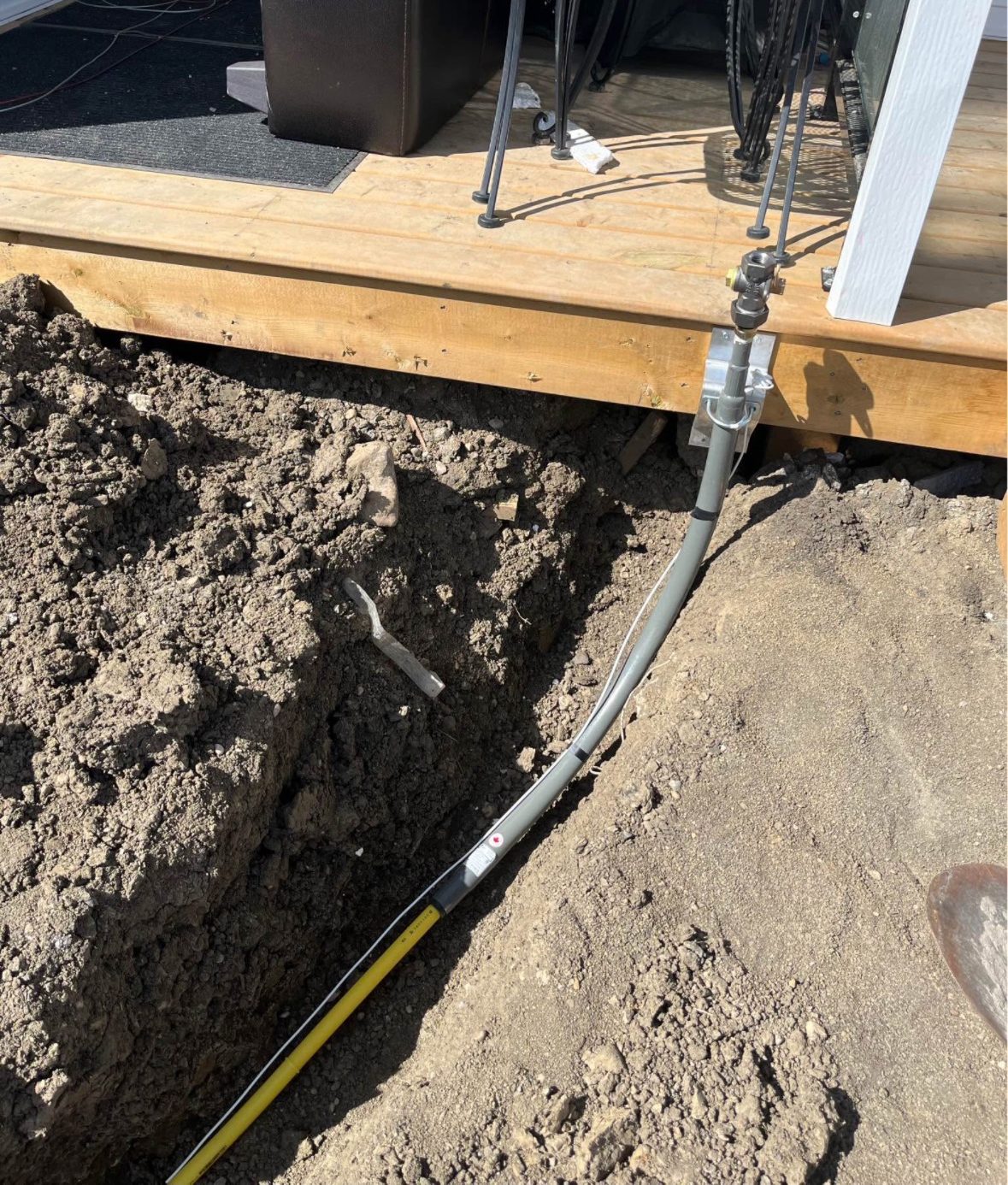 Gas line trenching under a deck by Sphinx Mechanical